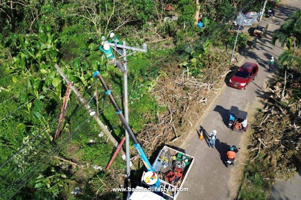 Negros Power crews working on top of the pole fixing the power lines